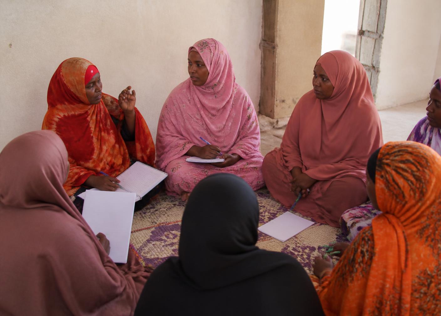 Women seated in a circle during a community workshop